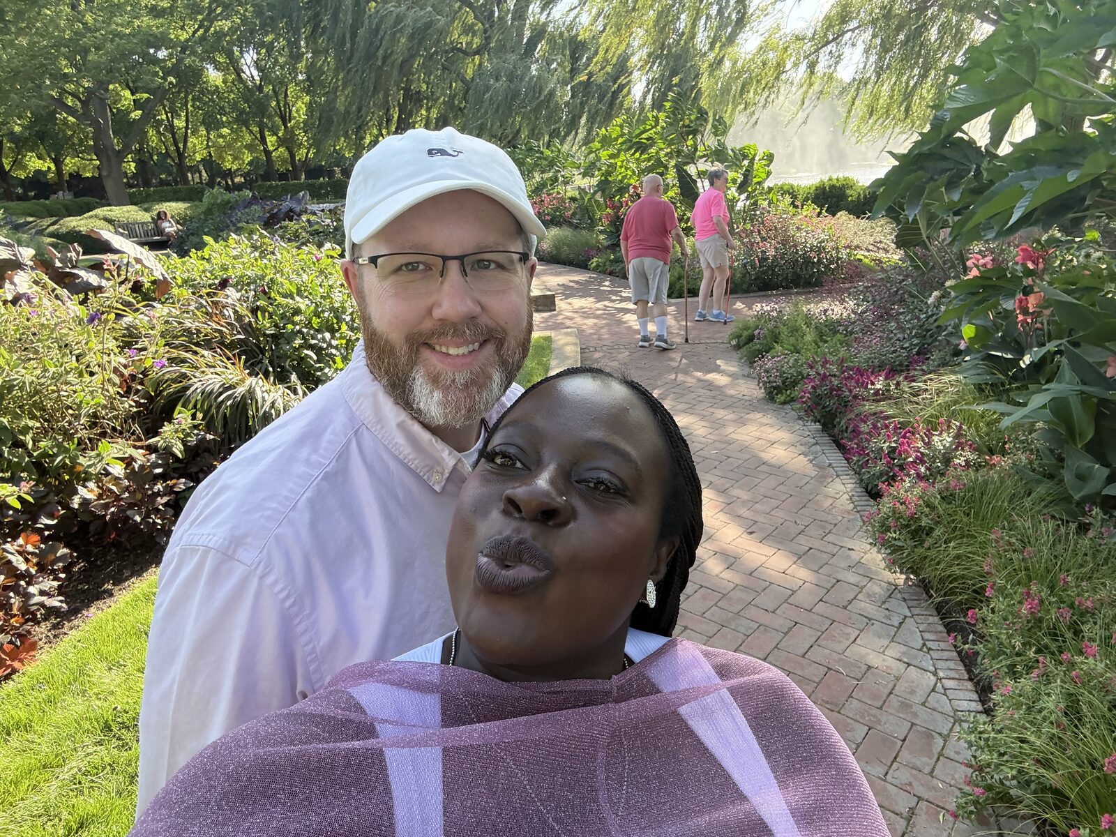 Kevin and Patricia smiling together on a garden path